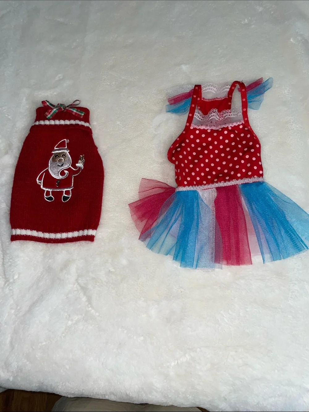Two dog outfits, size XS…one Christmas sweater & one 4th of July dress